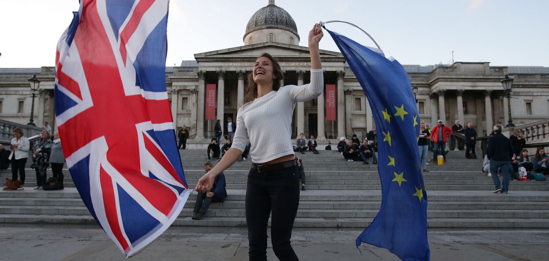 A woman waves the British and EU flags at a protest about the terms of the Brexit held in London's Trafalgar Square on Sept. 13, 2017.