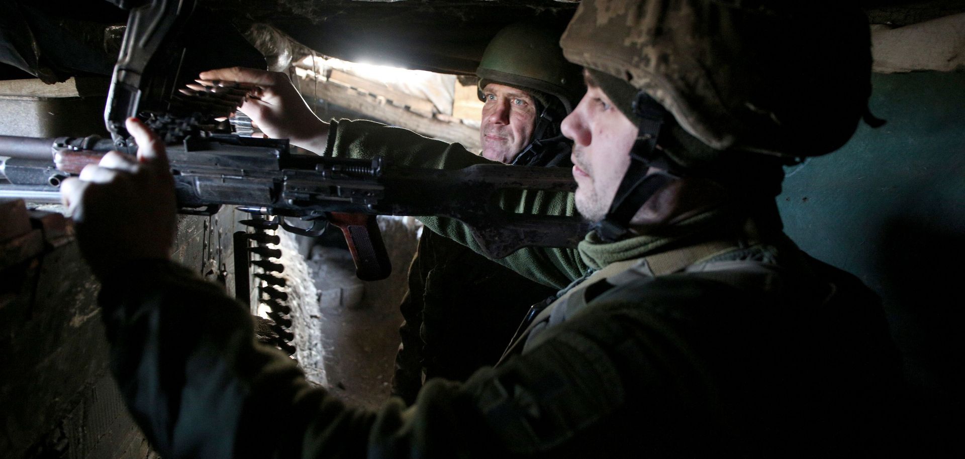 Ukrainian servicemen stand in position on the front line with Russia-backed separatists Feb. 19, 2021, in the Donetsk region.