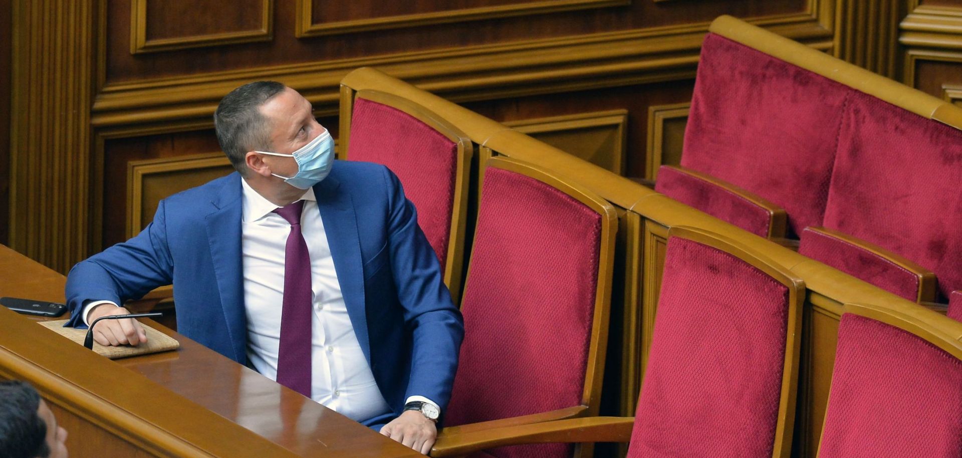 Ukraine's new central bank chief, Kyrylo Shevchenko, wears a face mask as he watches lawmakers vote on his candidacy during a parliamentary session on July 16, 2020.