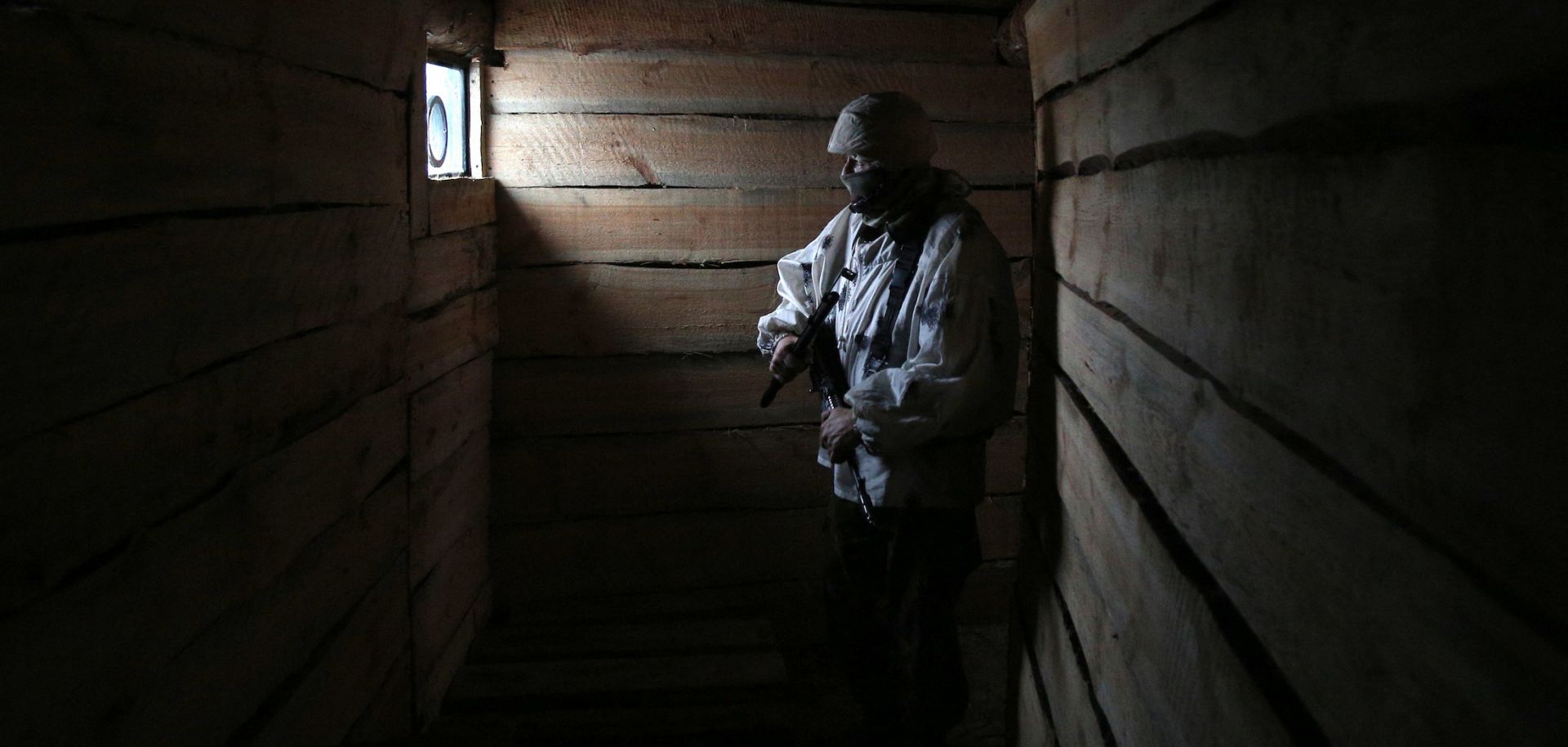A Ukrainian serviceman is seen in a dugout in the Donetsk region of eastern Ukraine on Feb. 2, 2022. 
