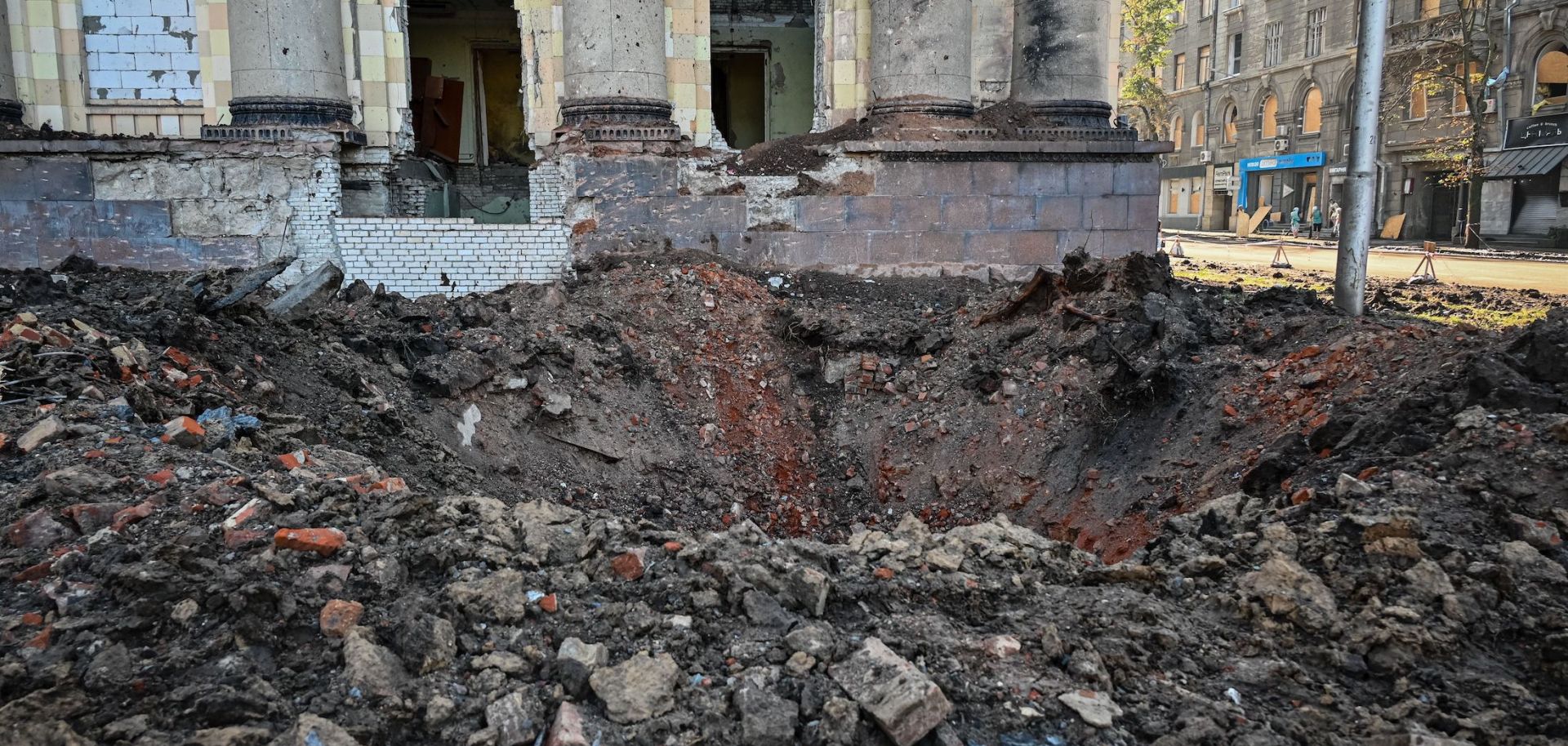 A crater near the damaged headquarters of the Kharkiv administration building following an overnight missile strike Aug. 29, 2022, in Kharkiv, Ukraine.