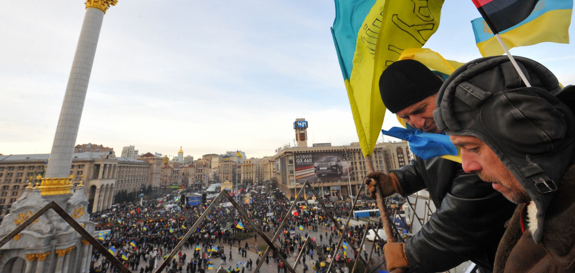 Opposition protesters place flags on surrounding buildings as thousands rallied in Independence Square in Kiev on Dec. 3. 