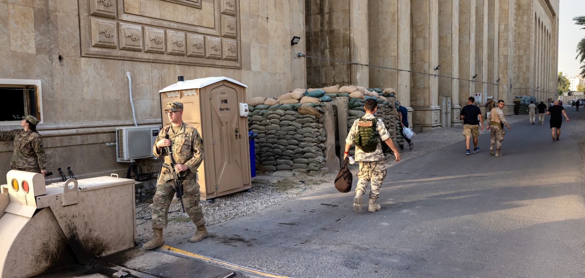 U.S. soldiers (L) on May 30, 2021, next to the former Baath Party headquarters near the entrance to the Green Zone in Baghdad.