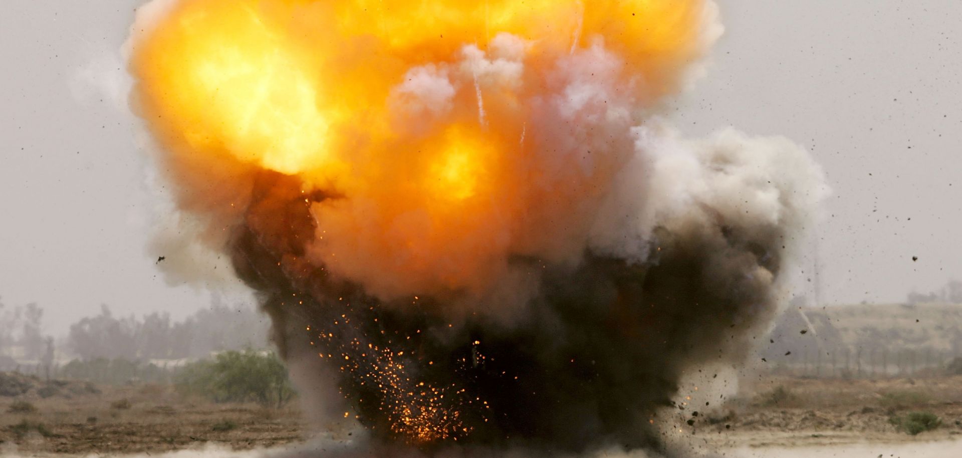 An improvised explosive device explodes next to a road.