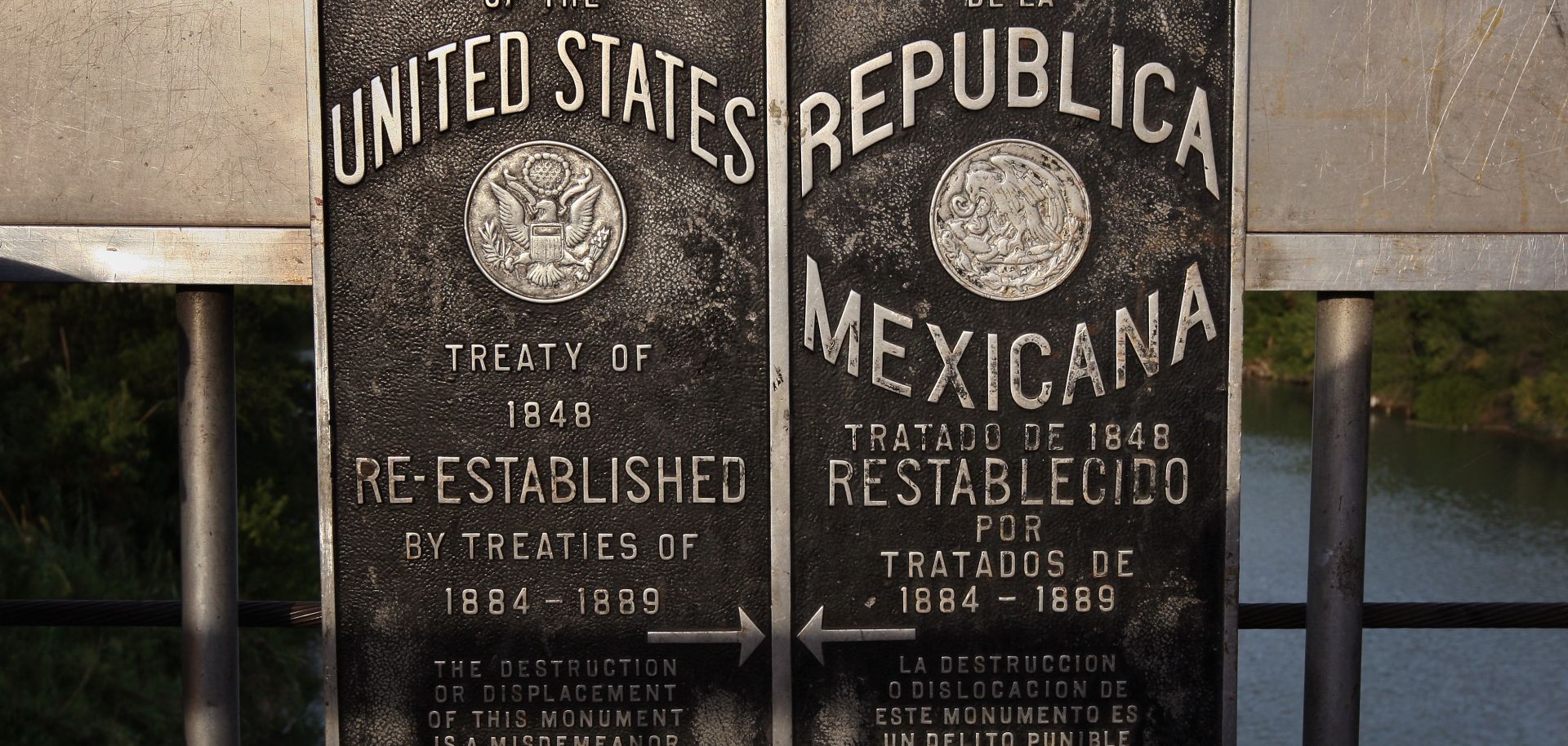 Signs mark the boundary between the United States and Mexico over the Rio Grande on Aug. 6, 2008, near Laredo, Texas.