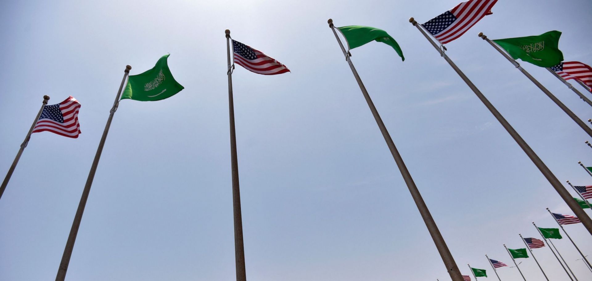 Saudi and U.S. flags line the King Abdulaziz Road in the Saudi Red Sea port city of Jeddah on July 14, 2022. 