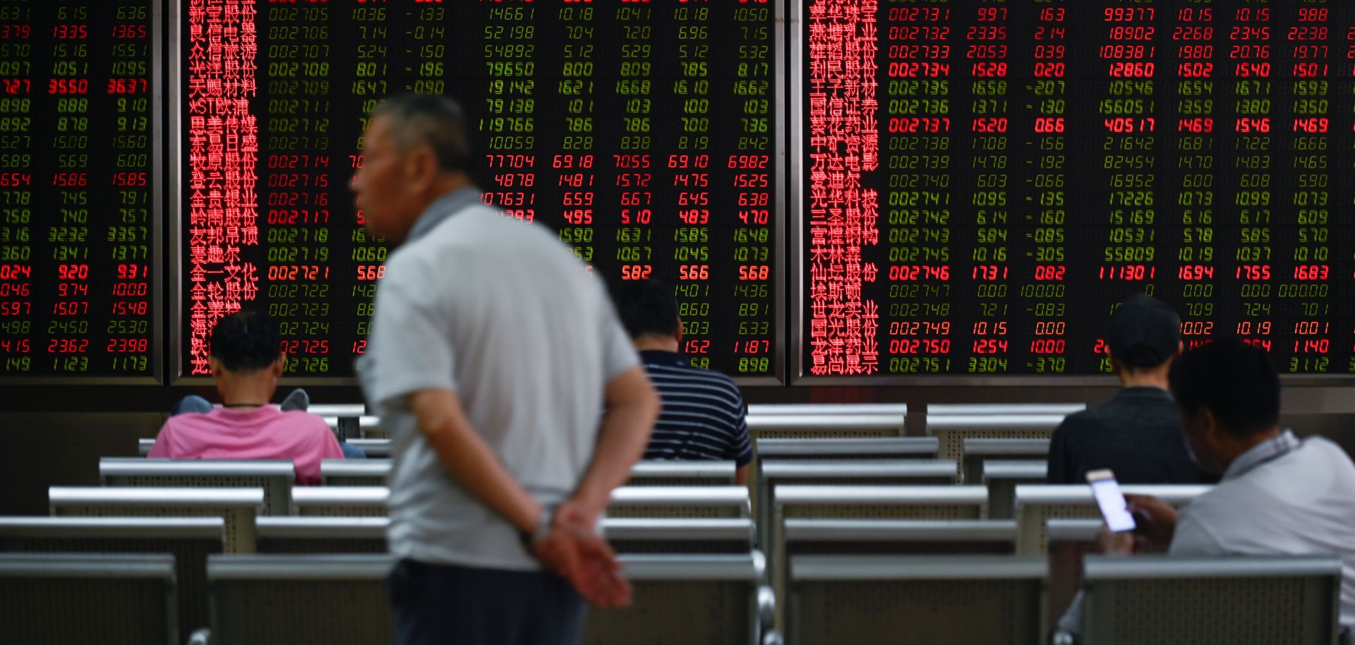 Chinese investors watch a stock ticker at a Beijing securities company on Aug. 26.