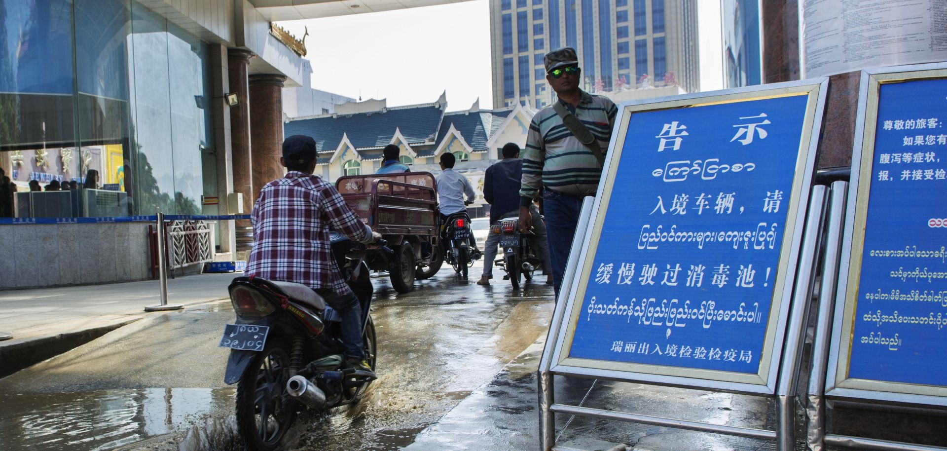 Vehicles crossing the gate from the Myanmar border town of Muse to the Chinese town of Ruili.