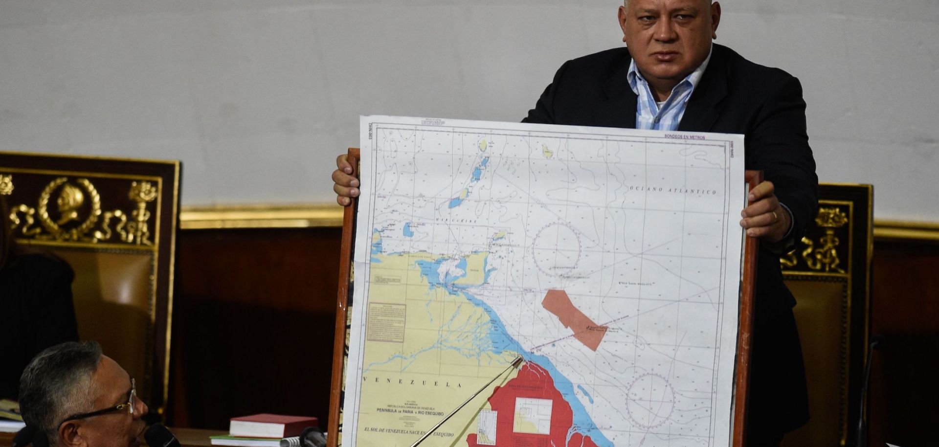 Venezuelan lawmaker Pedro Carreno (L) delivers a speech while Venezuelan deputy Diosdado Cabello (R) holds a map showing the border between Venezuela and Guyana during a legislative session in Caracas on Jan. 8, 2019.