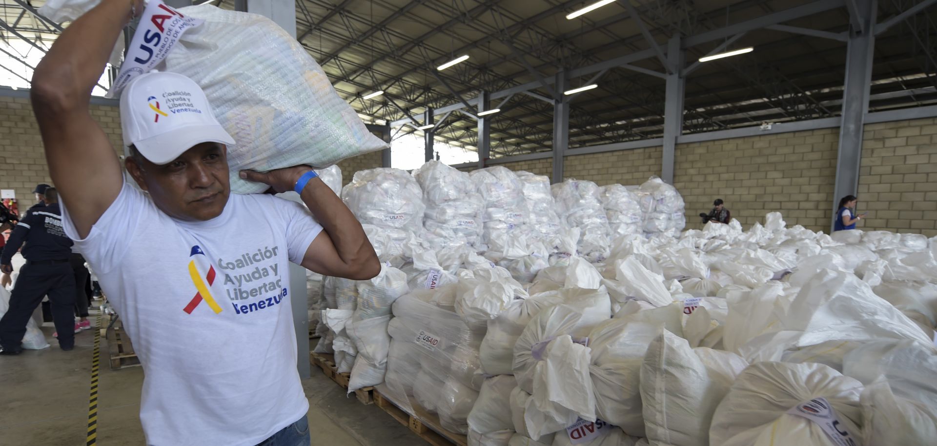 A volunteer helps stage U.S. humanitarian aid goods in Cucuta, Colombia, in preparation for an attempt to deliver them to Venezuela on Feb. 23.