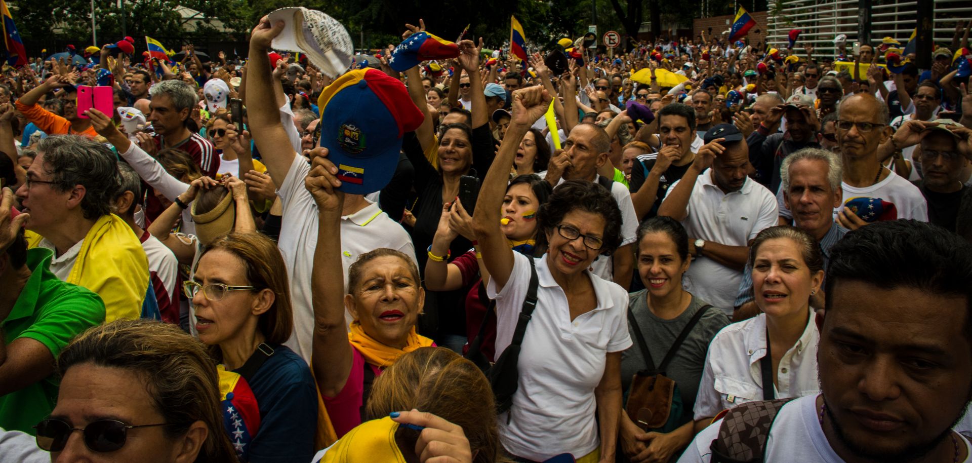 Numerous people wearing caps in the colors of the Venezuelan flag take part in a protest against the government of President Nicolas Maduro on Venezuela's day of independence.