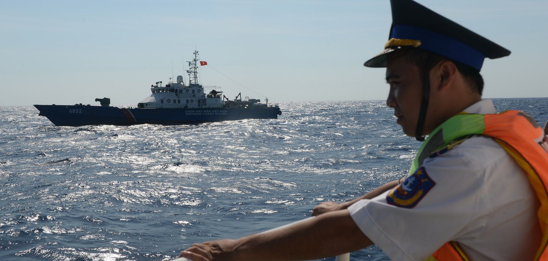 A Vietnamese coast guard officer looks toward a Vietnamese coast guard ship sailing in an area near a Chinese oil-drilling rig in disputed waters of the South China Sea, in May 2014.