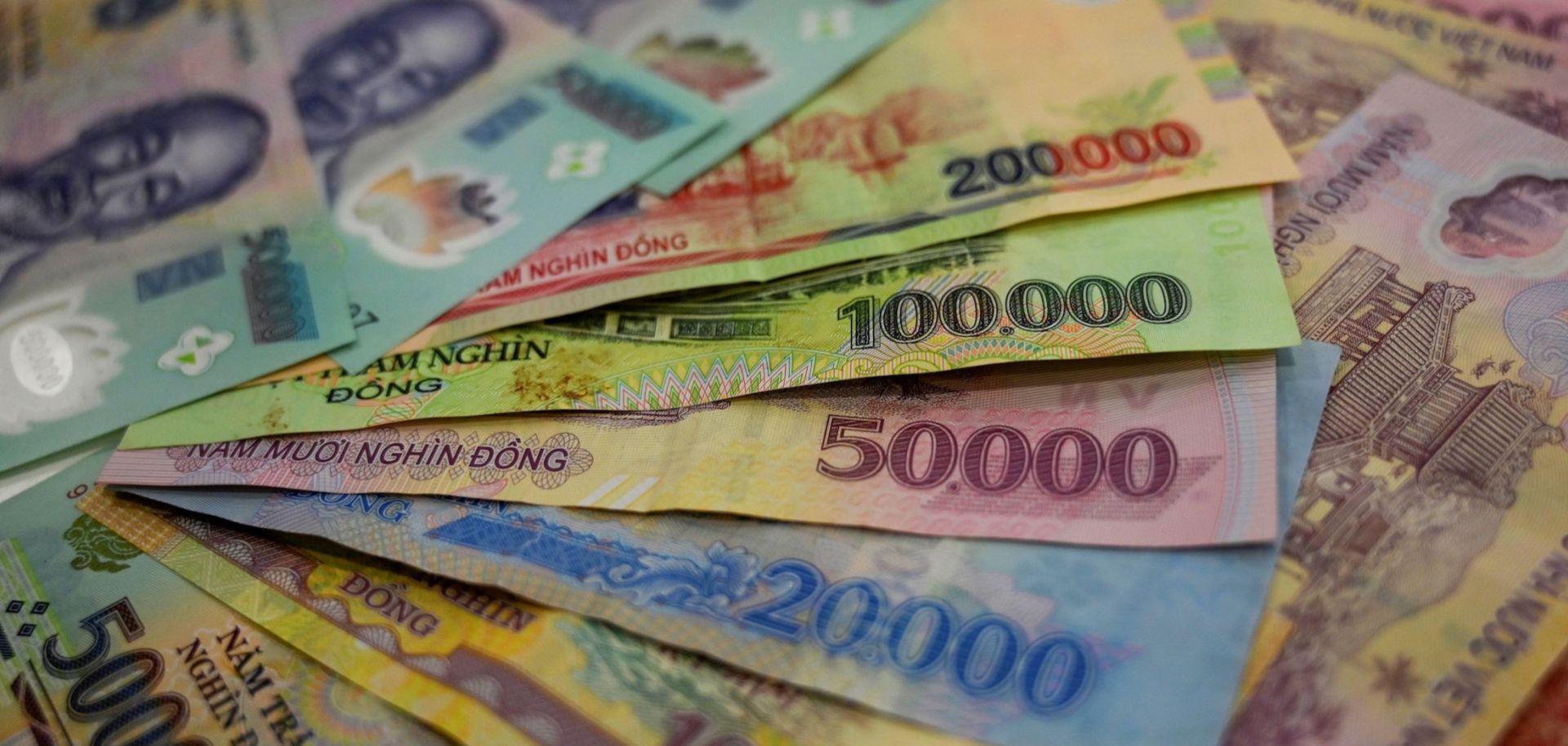 A photo illustration shows banknotes of the Vietnamese dong.  