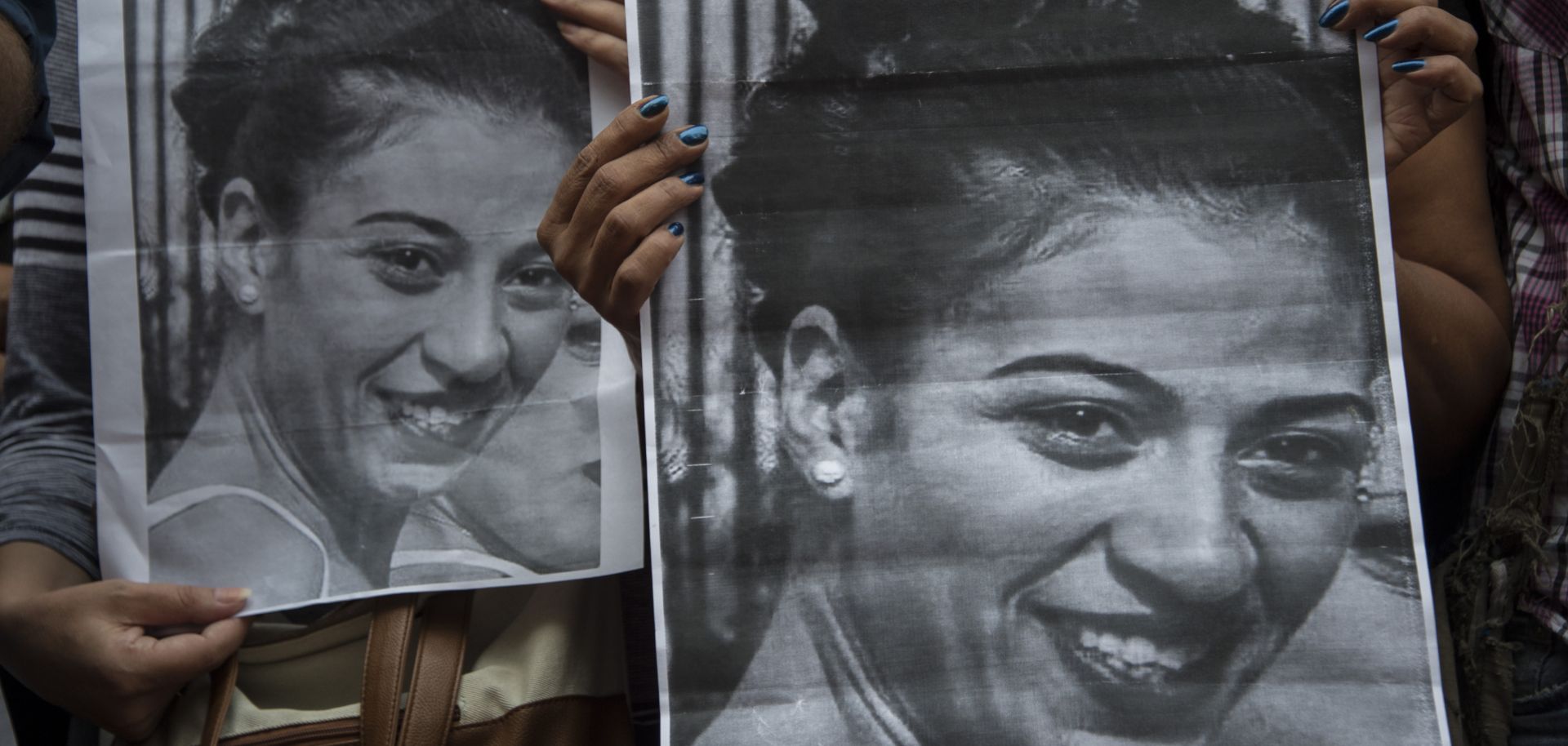 Protesters hold pictures of Valeria Sosa, a 29-year-old dancer killed by her former partner, as they march to condemn violence against women in Montevideo, Uruguay, on Feb. 2, 2017.