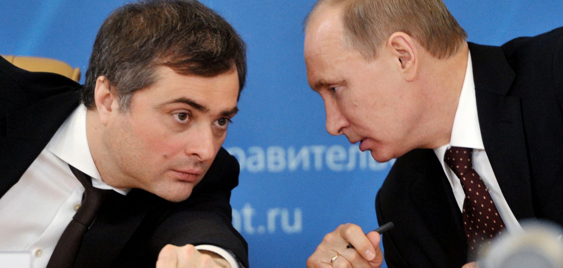 Russia's Prime Minister Vladimir Putin confers with his deputy Vladislav Surkov.