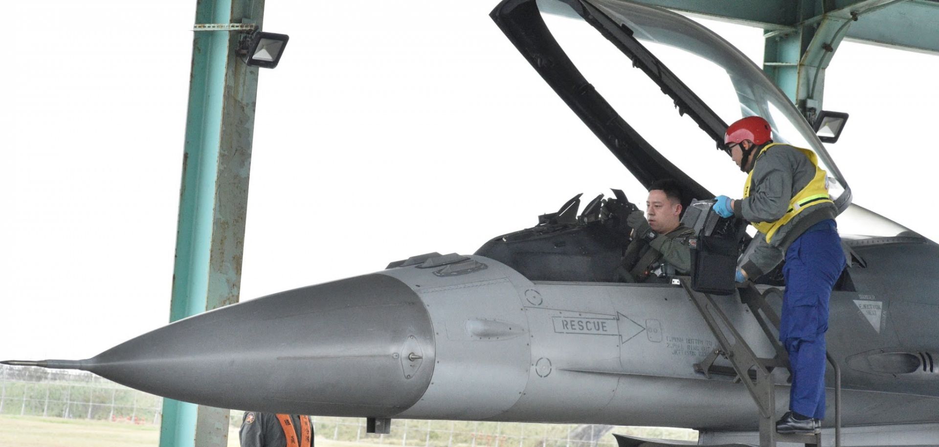 A pilot checks a F-16 during a drill at an air base in Taiwan