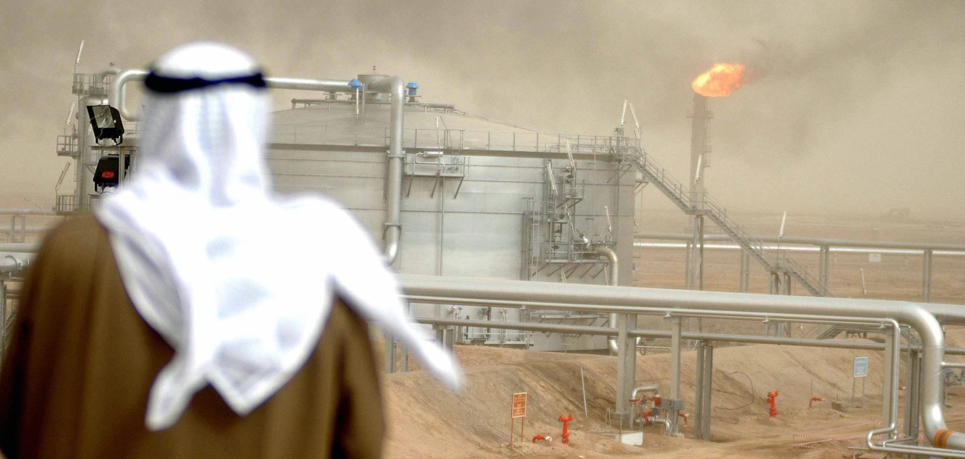 In this January 2005 file image, a Kuwait Oil Company employee looks at a newly opened oil-gathering center north of Kuwait City.