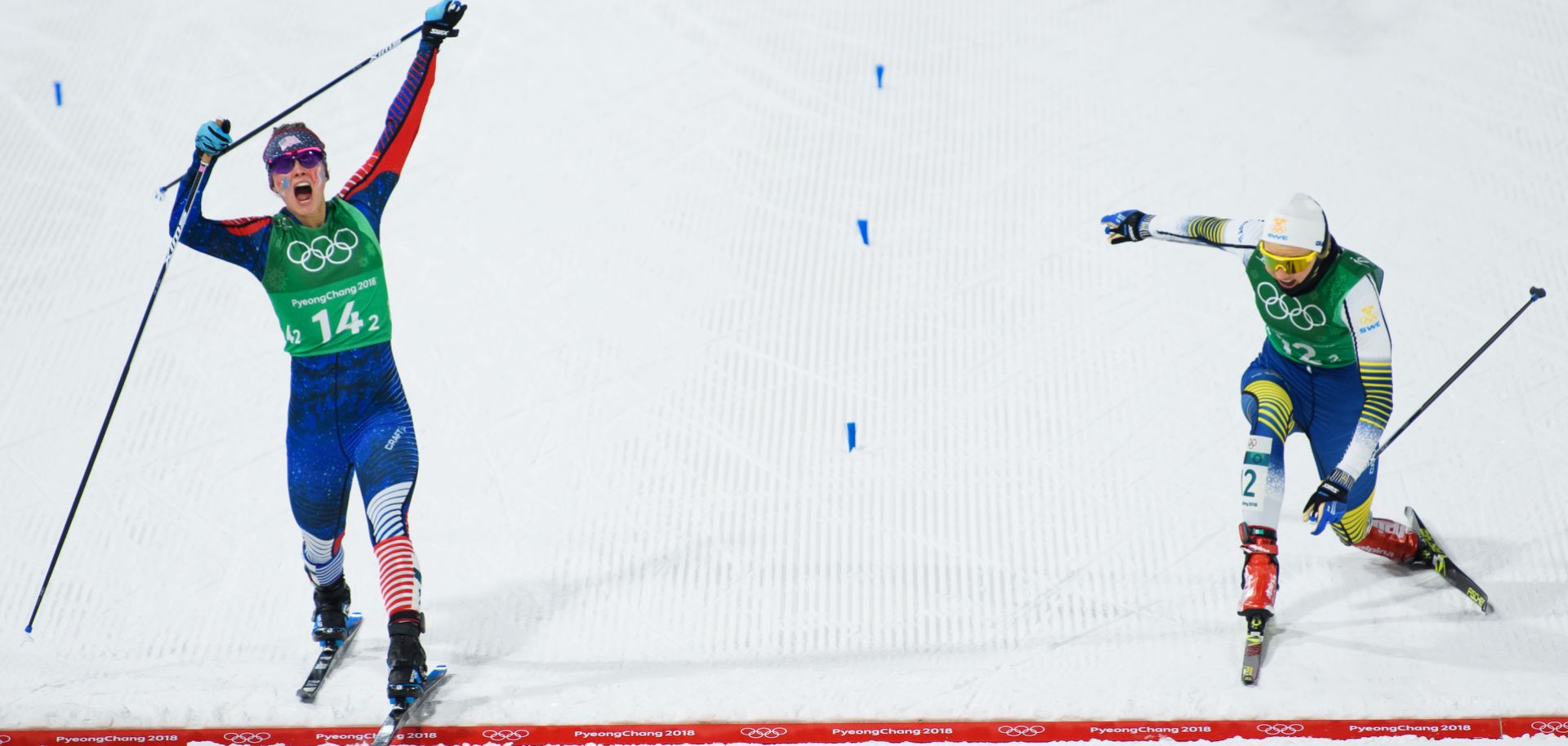 U.S. cross-country skier Jessica Diggins (L) crosses the finish line ahead of Swedish skier Stina Nilsson to win gold in the sprint event at the Winter Olympics in Pyeongchang, South Korea.