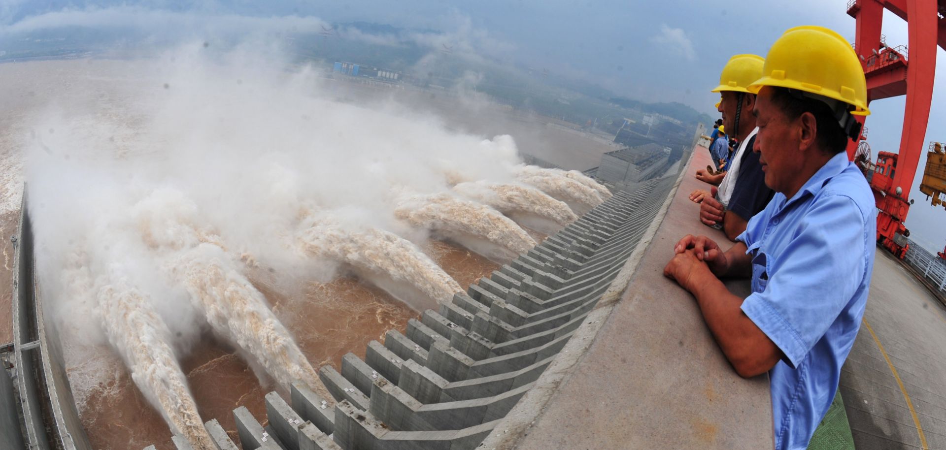 Workers watch in 2012 as water is released from the Three Gorges Dam, a gigantic hydropower project on the Yangtze River in central China.