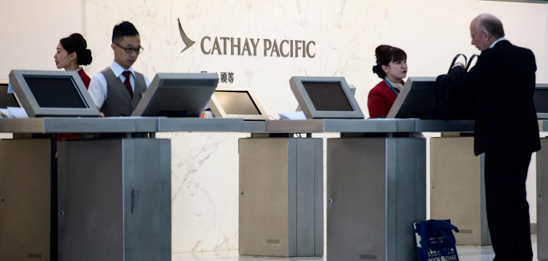 An employee of Cathay Pacific Airways helps a customer at Hong Kong's international airport on Aug. 7, 2018.
