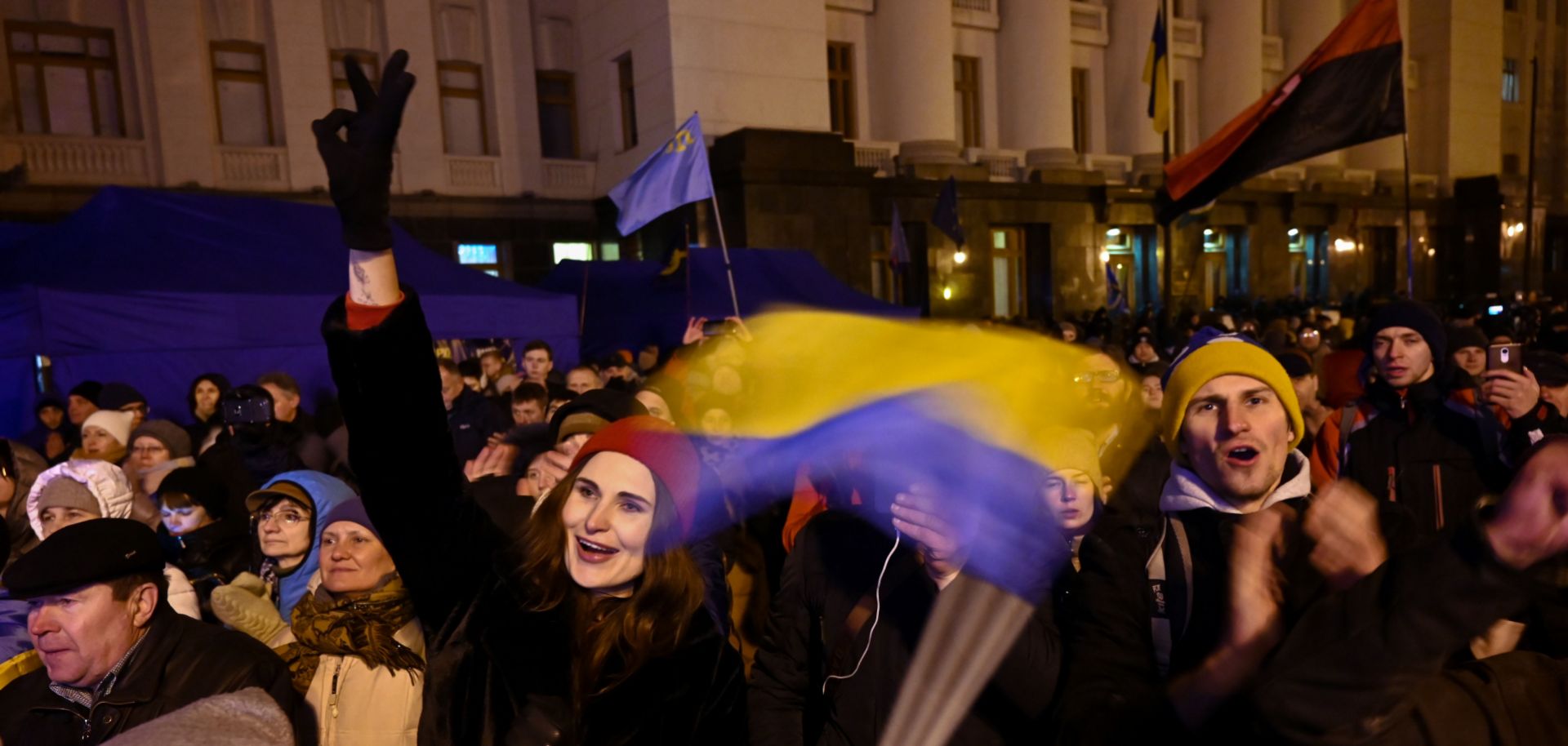 People gather outside the presidential office in Kyiv on Dec. 9, 2019, as they wait for news of talks held in Paris to try to end the conflict in eastern Ukraine.