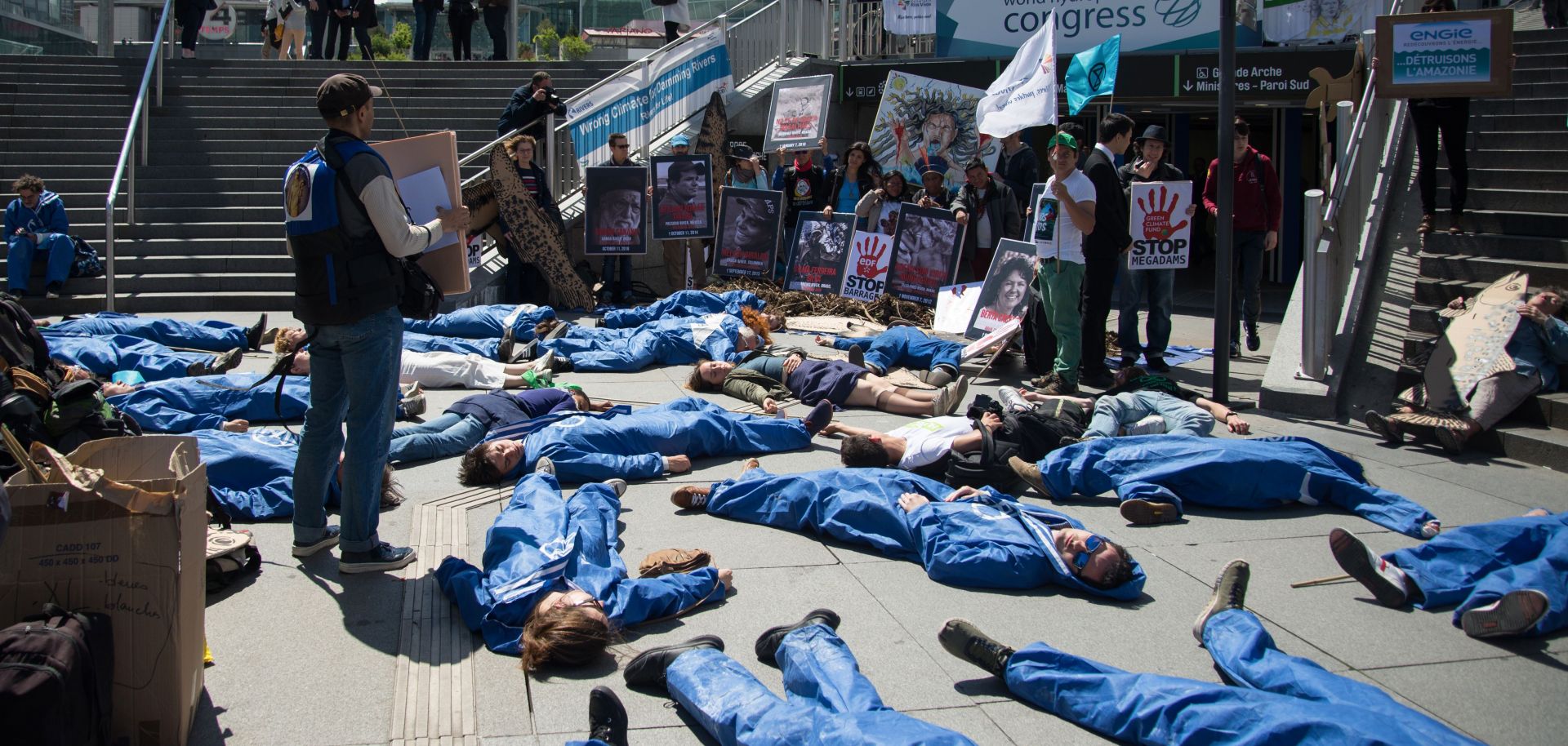 Extinction Rebellion and Planete Amazone activists stage a "die-in" on May 14, 2019, in front of the Grande Arche de La Defense in Puteaux, northwest of Paris.