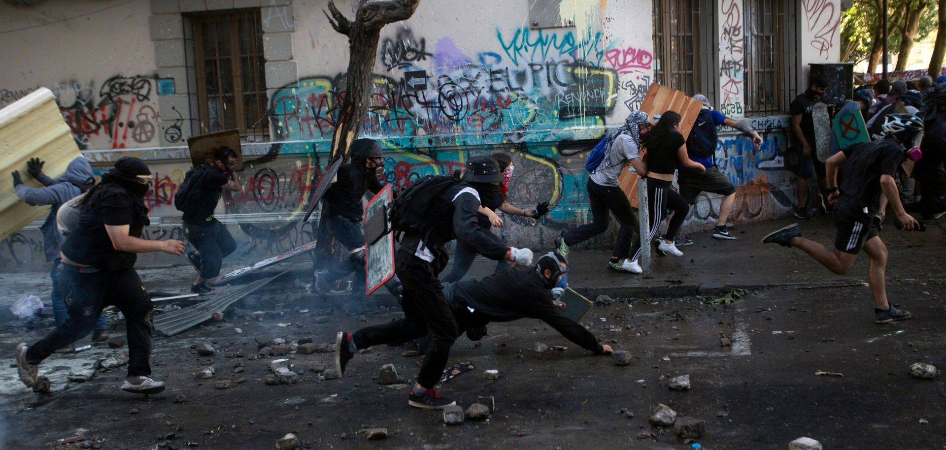 This photo shows protesters in Santiago, Chile, running from riot police on Nov. 19, 2019.