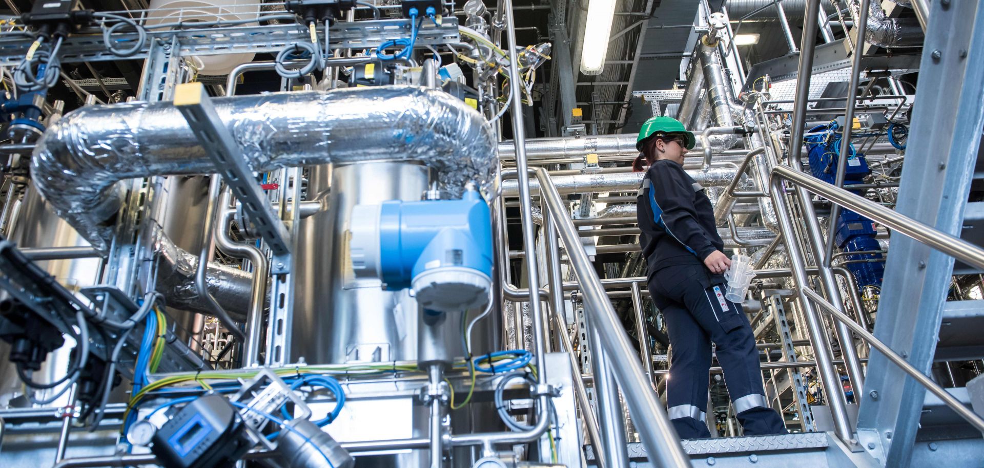 Biotechnology engineer Jenny Pietzsch walks through a demo plant of the French company Global Bioenergies during its inauguration ceremony in Leuna, Germany, on May 11, 2017.