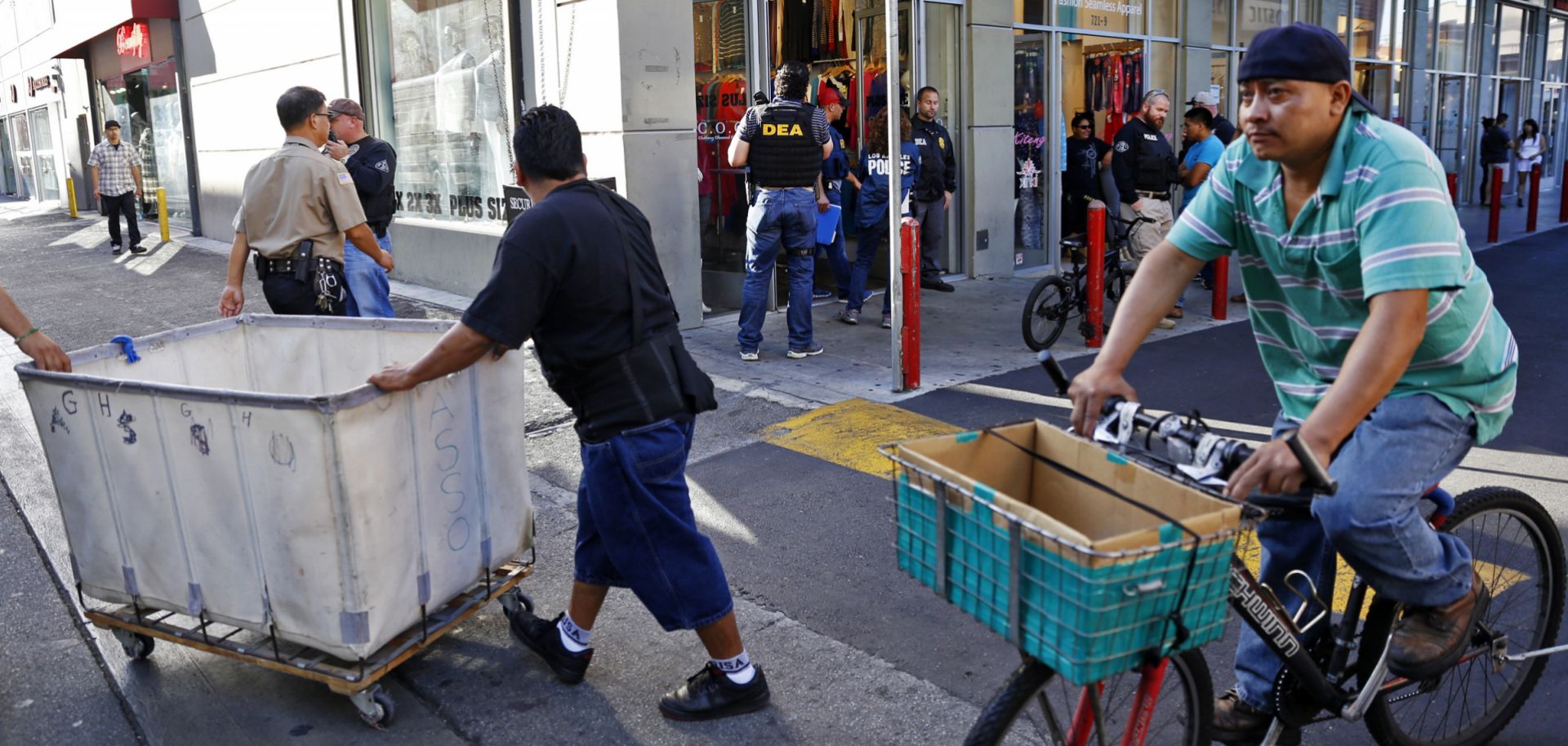 In this photo, authorities raid a fashion storefront in downtown Los Angeles on Sept. 10, 2014, as part of an investigation into the alleged laundering of narcotics profits by Mexican drug cartels.