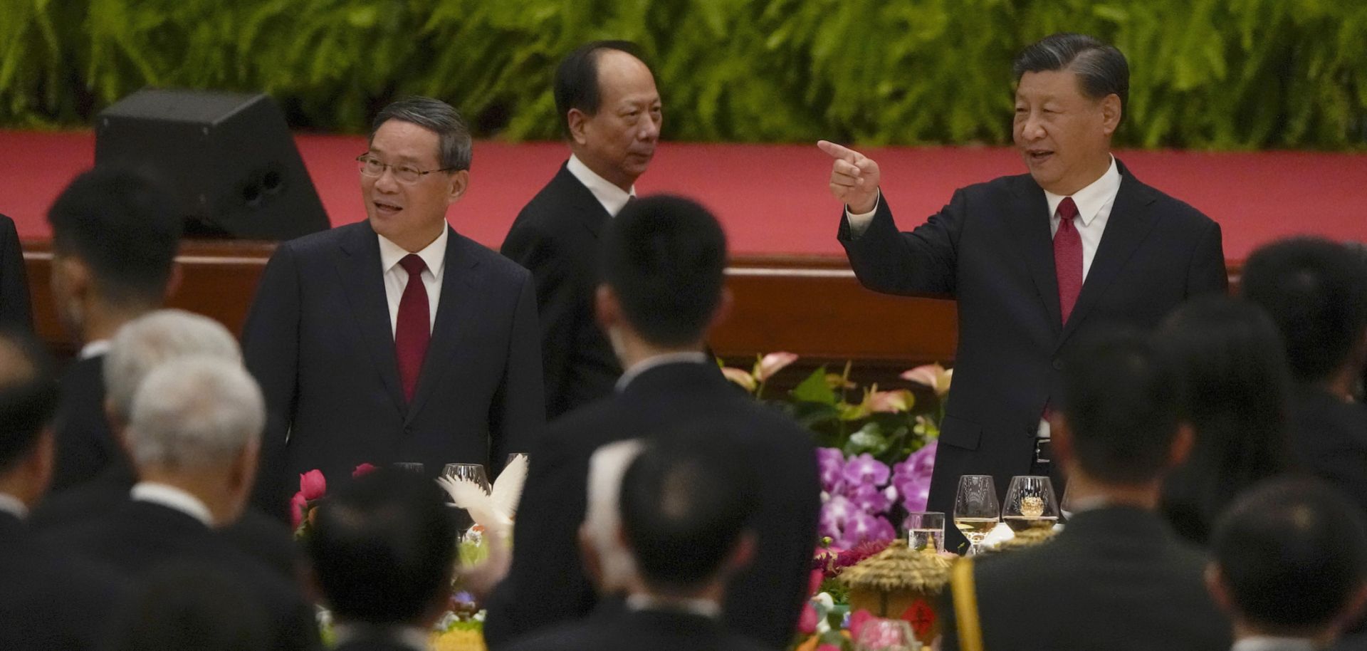 Chinese President Xi Jinping (right) gestures as he and his Premier Li Qiang (left) arrive for a dinner marking the 74th anniversary of the founding of the People's Republic of China on Sept. 28, 2023, in Beijing, China. 