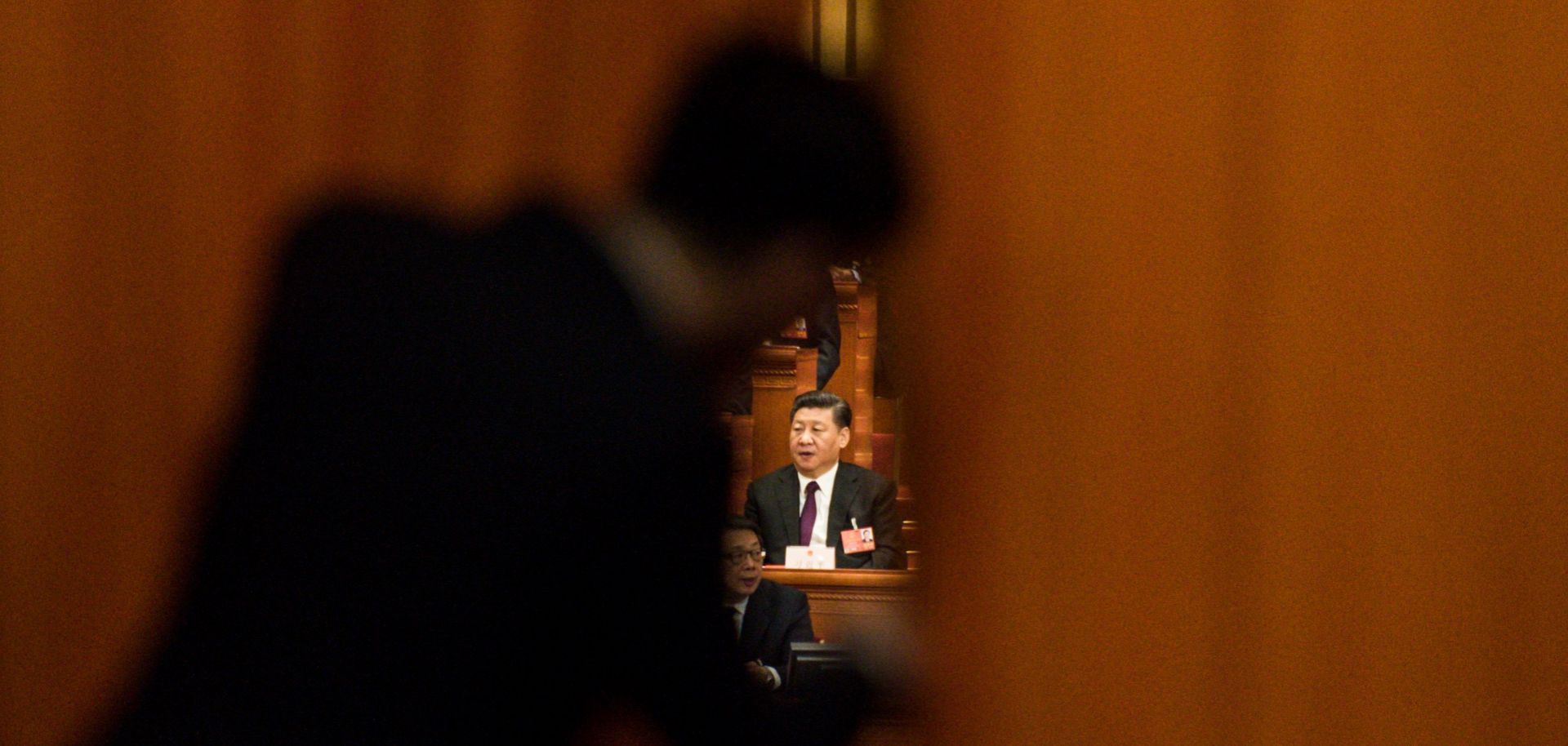 Chinese President Xi Jinping (C) attends a session of the 13th National People's Congress of China on March 17.