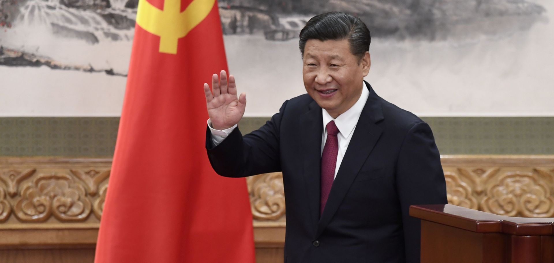 Chinese President Xi Jinping waves after introducing the new members of China's top decision-making body, the Communist Party's Politburo Standing Committee, on Oct. 25 in Beijing.