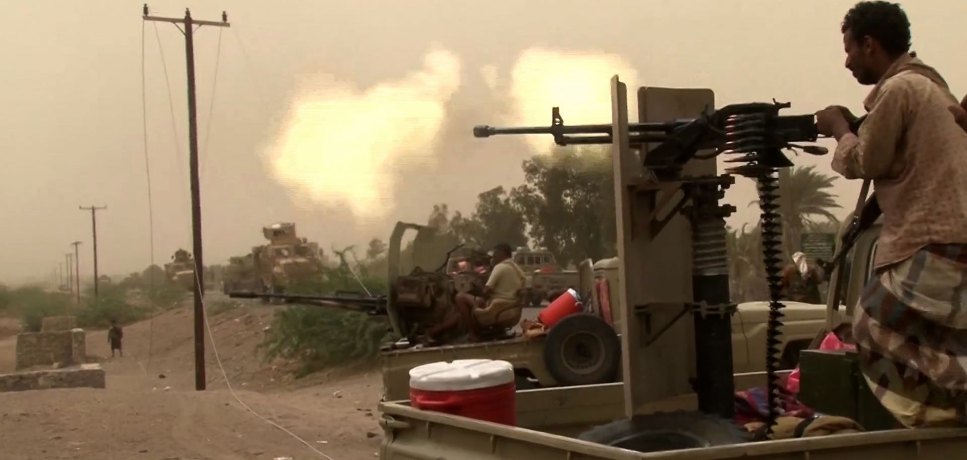  This photo shows a member of Yemen's pro-government forces firing a machine gun south of the airport near al-Hudaydah.