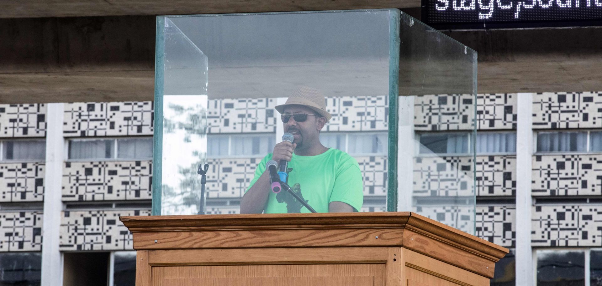 Ethiopian Prime Minister Abiy Ahmed addresses a rally behind protective glass in Addis Ababa on June 23.