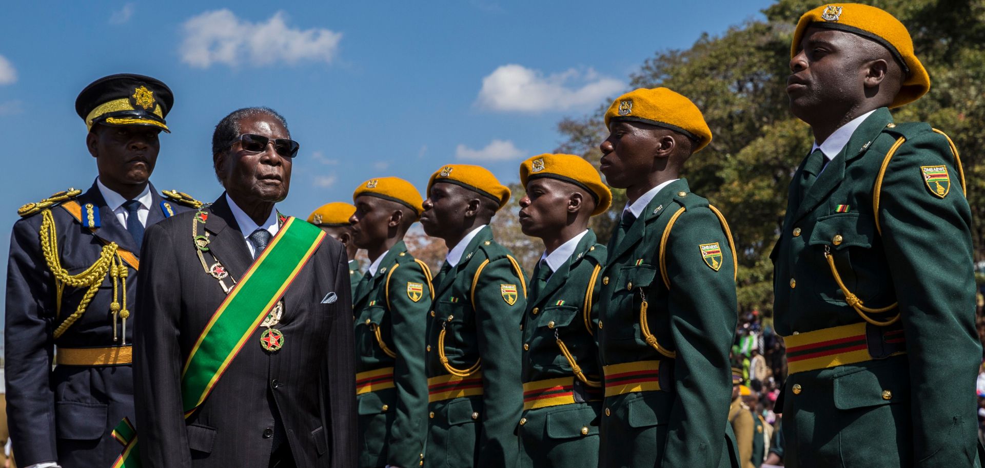 Zimbabwean President Robert Mugabe (in the green sash) inspects a guard of honor during official Heroes Day commemorations held at National Heroes Acre in Zimbabwe, Aug. 14.