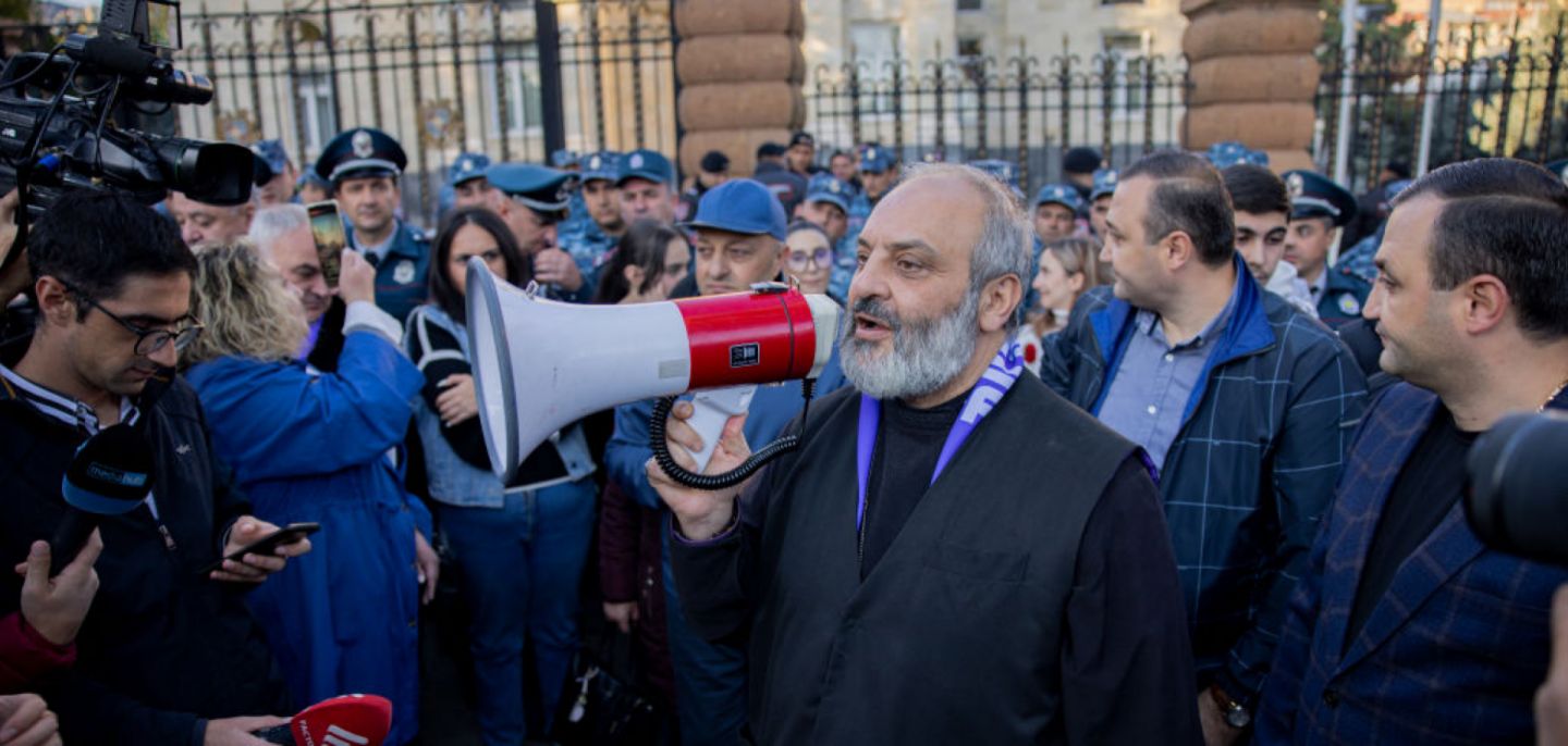 Archbishop Bagrat Galstanyan addresses the crowd with a megaphone during a protest in Yerevan, Armenia, on Oct. 25, 2024. 