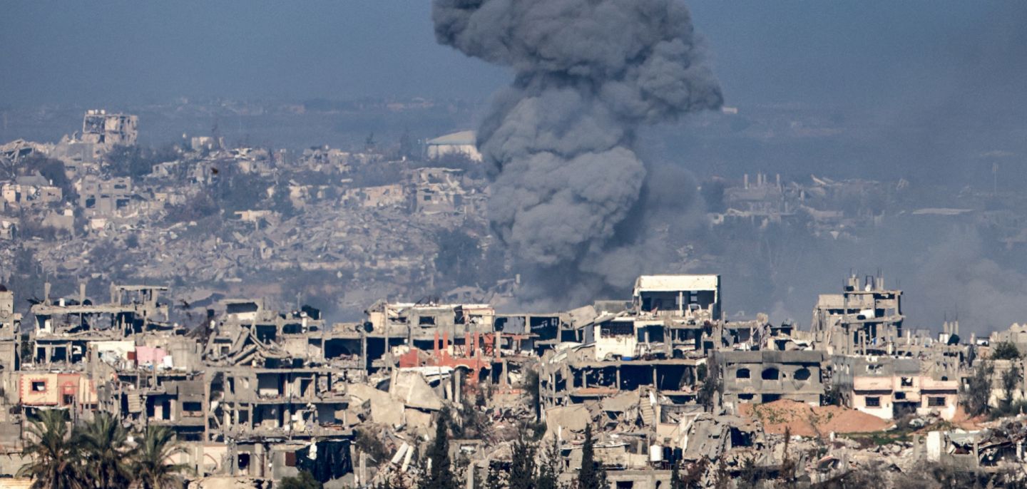 A smoke plume rises above destroyed buildings in northern Gaza on Jan. 13, 2025.