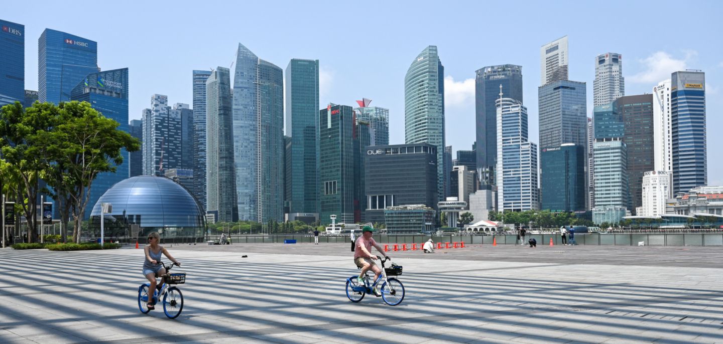 People cycle along the promenade at Marina Bay in Singapore on Oct. 13, 2023. People cycle along the promenade at Marina Bay in Singapore on Oct. 13, 2023.