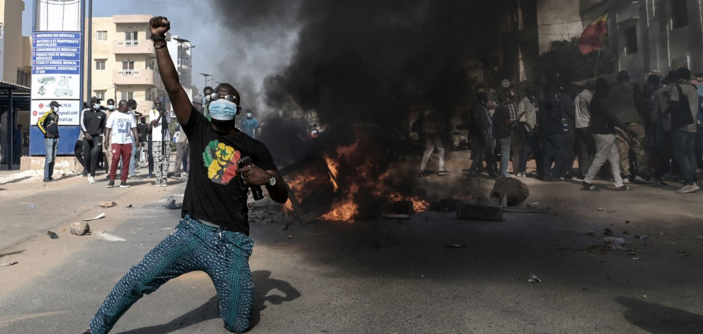 An opposition supporter reacts in front of a burning barricade during demonstrations in Dakar, Senegal, on Feb. 4, 2024, after President Macky Sall announced the postponement of the presidential election. An opposition supporter reacts in front of a burning barricade during demonstrations in Dakar, Senegal, on Feb. 4, 2024, after President Macky Sall announced the postponement of the presidential election.