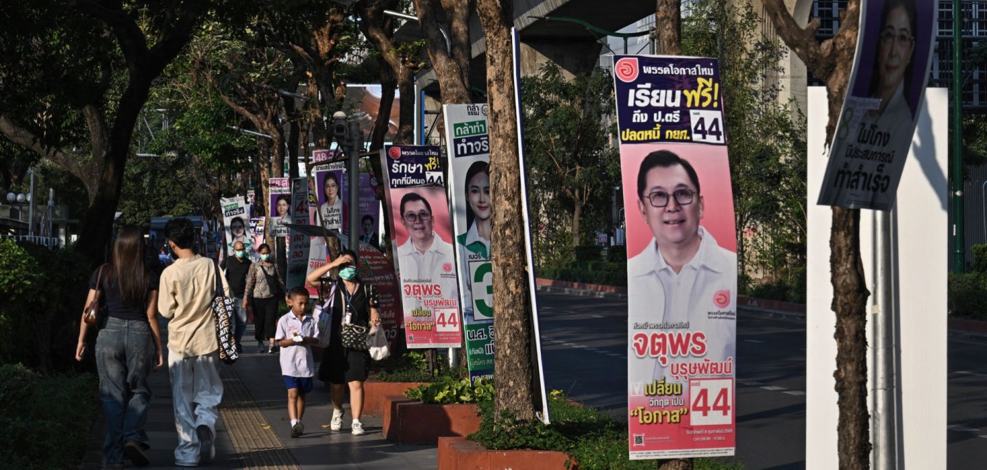 People walk past campaign posters in Bangkok on Feb. 2, 2026, ahead of Thailand's Feb. 8 general election.