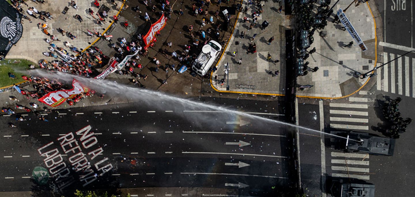 An aerial photo shows Argentinian police using a water cannon truck against protesters opposing labor reforms on Feb. 11, 2026, in Buenos Aires, Argentina.