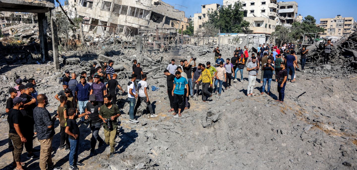 People gather by the rubble of destroyed buildings following an Israeli strike on an industrial area in Gaza City on July 12. People gather by the rubble of destroyed buildings following an Israeli strike on an industrial area in Gaza City on July 12.