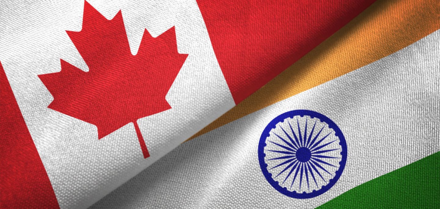 A digital illustration of the Indian and Canadian flags.