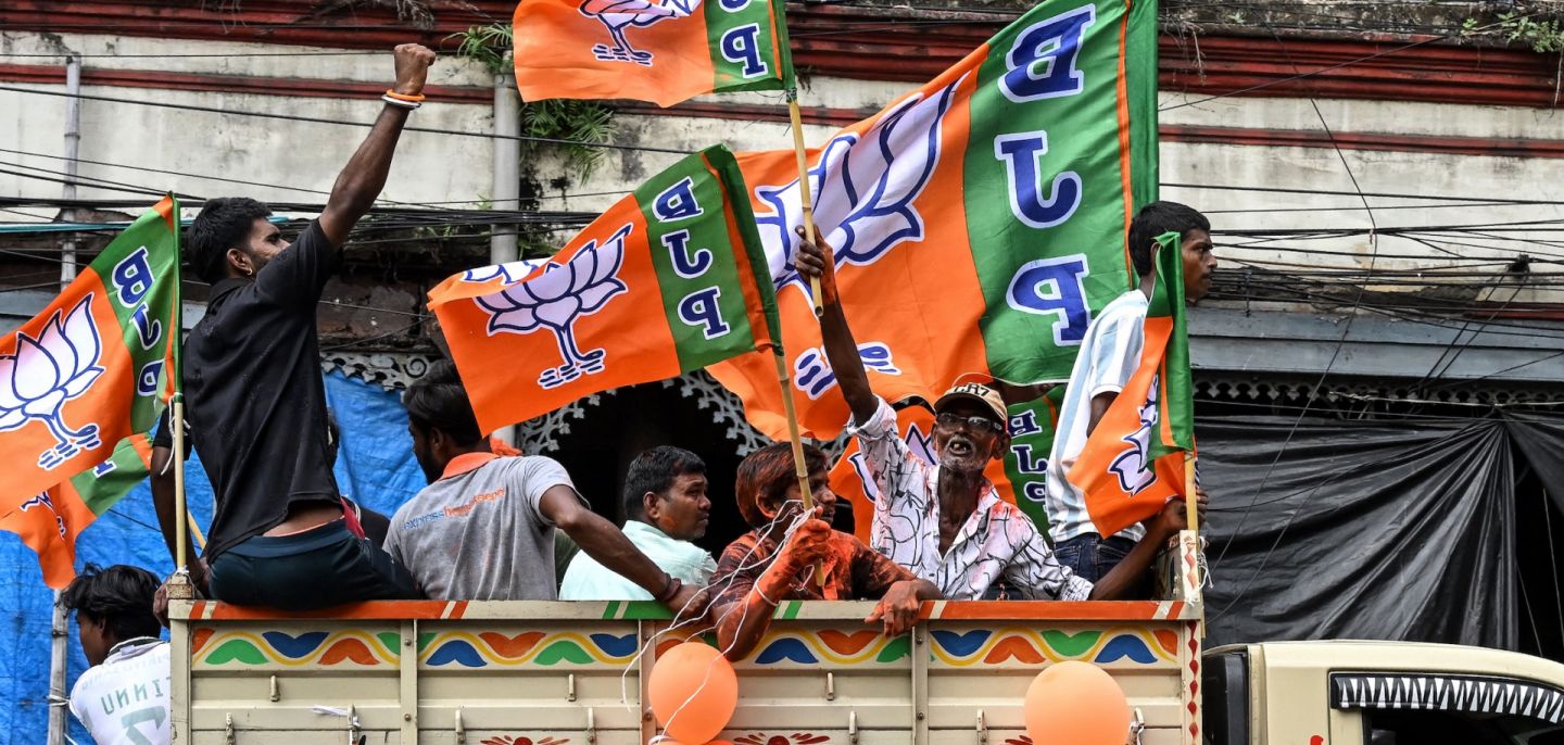 Supporters of the Bharatiya Janata Party (BJP) celebrate with the party flags in Kolkata, India, following state elections in West Bengal.