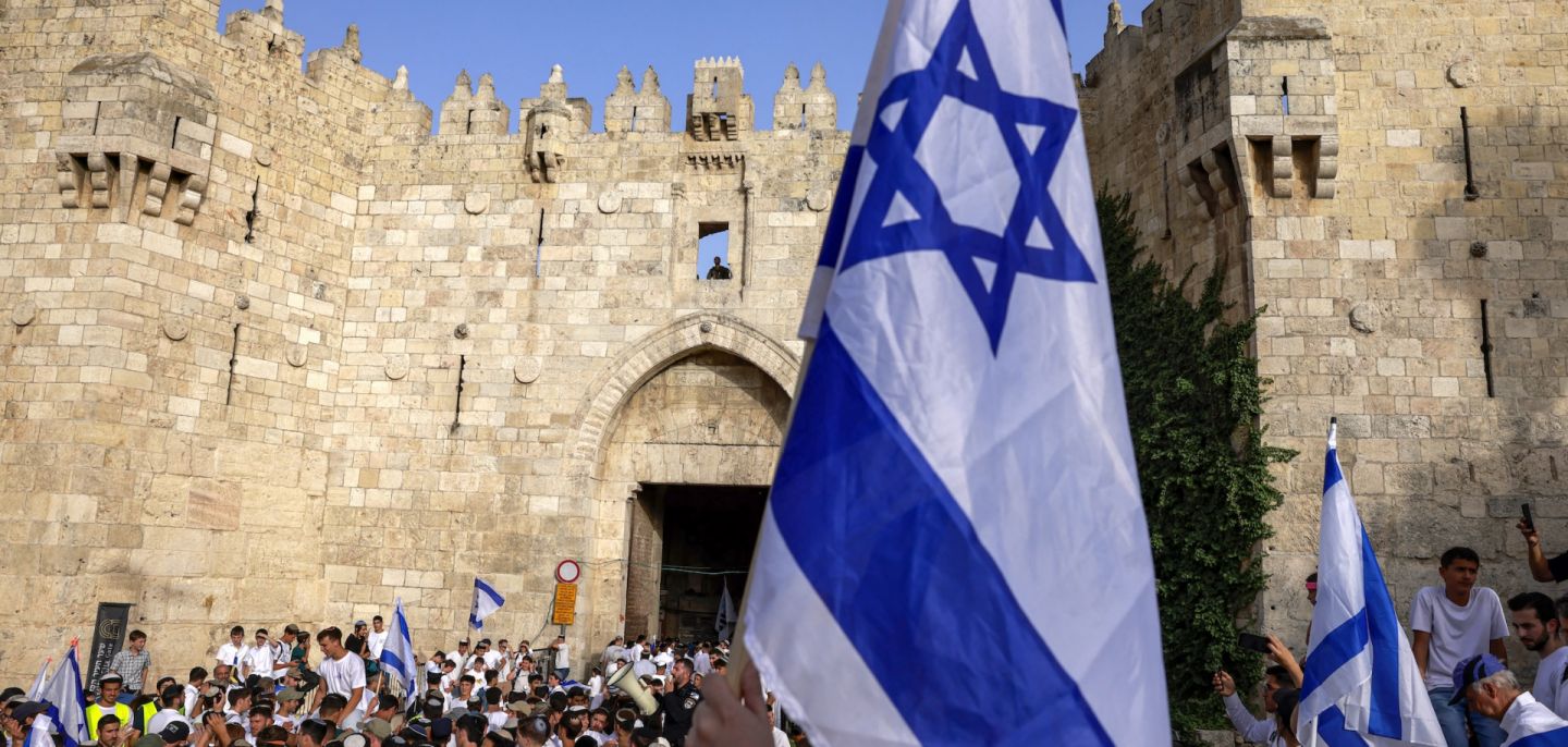 Right-wing activists gather with Israeli flags outside the Damascus Gate of the walled Old City of Jerusalem on May 26, 2025, during a flag march for Jerusalem Day, commemorating the Israeli army's 1967 capture of the city's eastern sector during the Arab-Israeli war.
