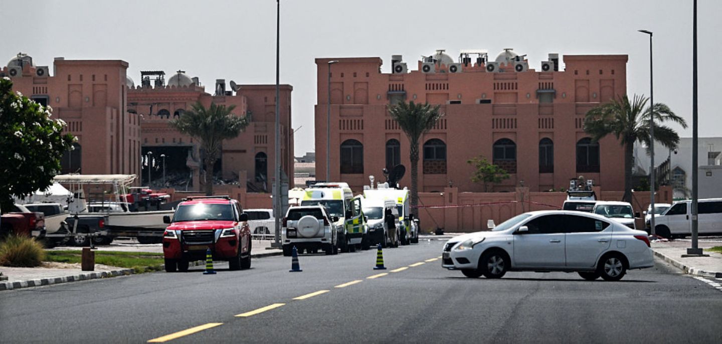 A picture taken from a distance shows the damaged building (L) in the Qatari compound housing members of Hamas' political bureau on Sept. 10, 2025. Israel targeted the building the previous day in a strike in Qatar's capital, Doha. 