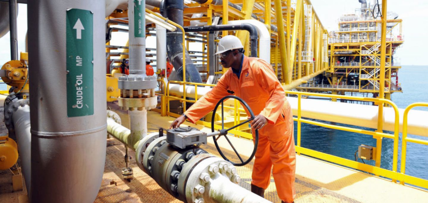A worker inspects an oil drilling platform located roughly 35 kilometers away from Port Harcourt in the Niger Delta. 