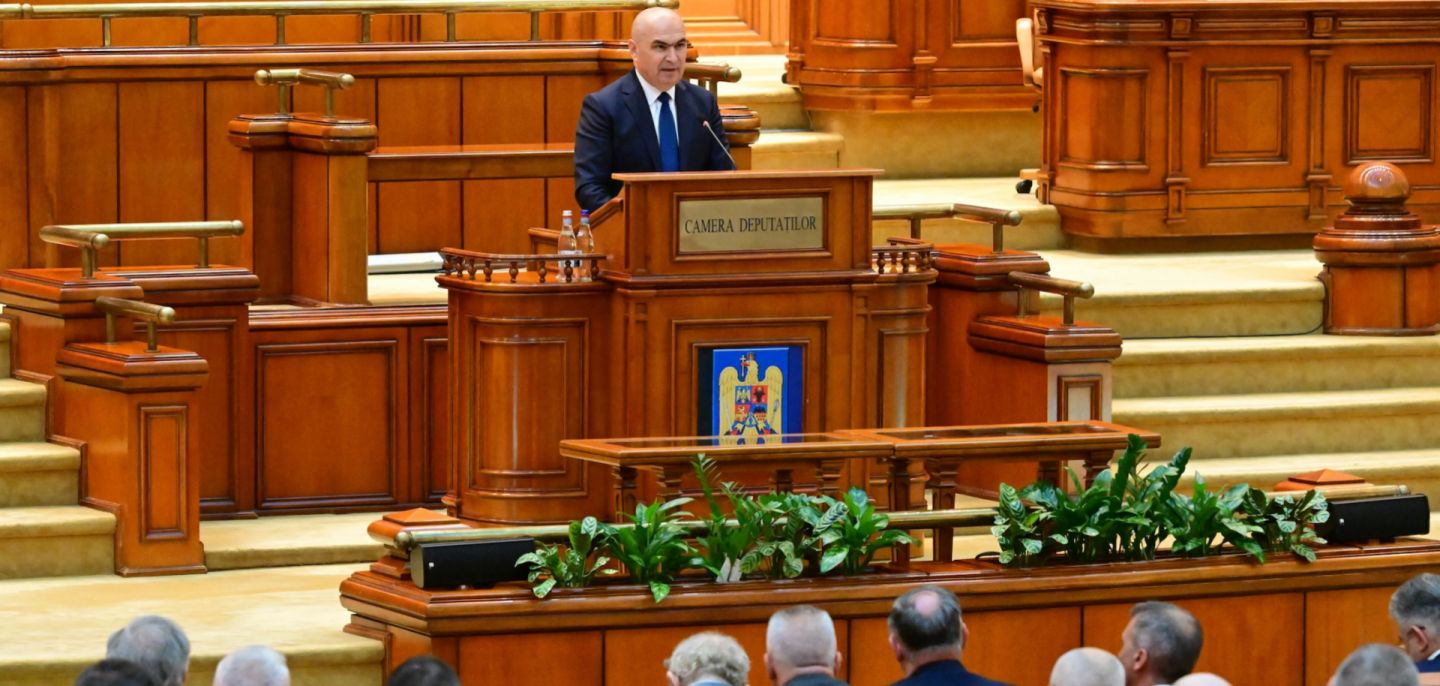 Romanian Prime Minister Ilie Bolojan delivers a speech to lawmakers in parliament in Bucharest on June 23, 2025.