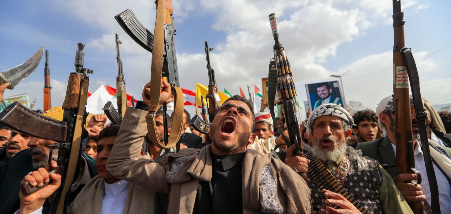 Armed Yemeni supporters of the Iran-backed Houthi movement brandish their weapons during a protest against U.S. strikes on Iran in Sanaa on July 10, 2026. 