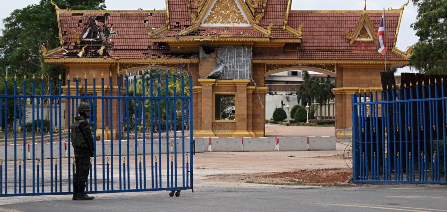 A Thai soldier stands guard at a damaged border crossing point between Surin province's Chong Chom and O'Smach town on the Thai-Cambodian border, on March 12, 2026.